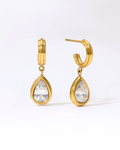 Gold hoop earrings with teardrop stone in a gold bezel.