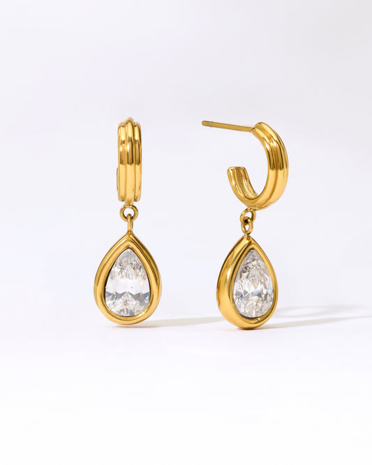 Gold hoop earrings with teardrop stone in a gold bezel.