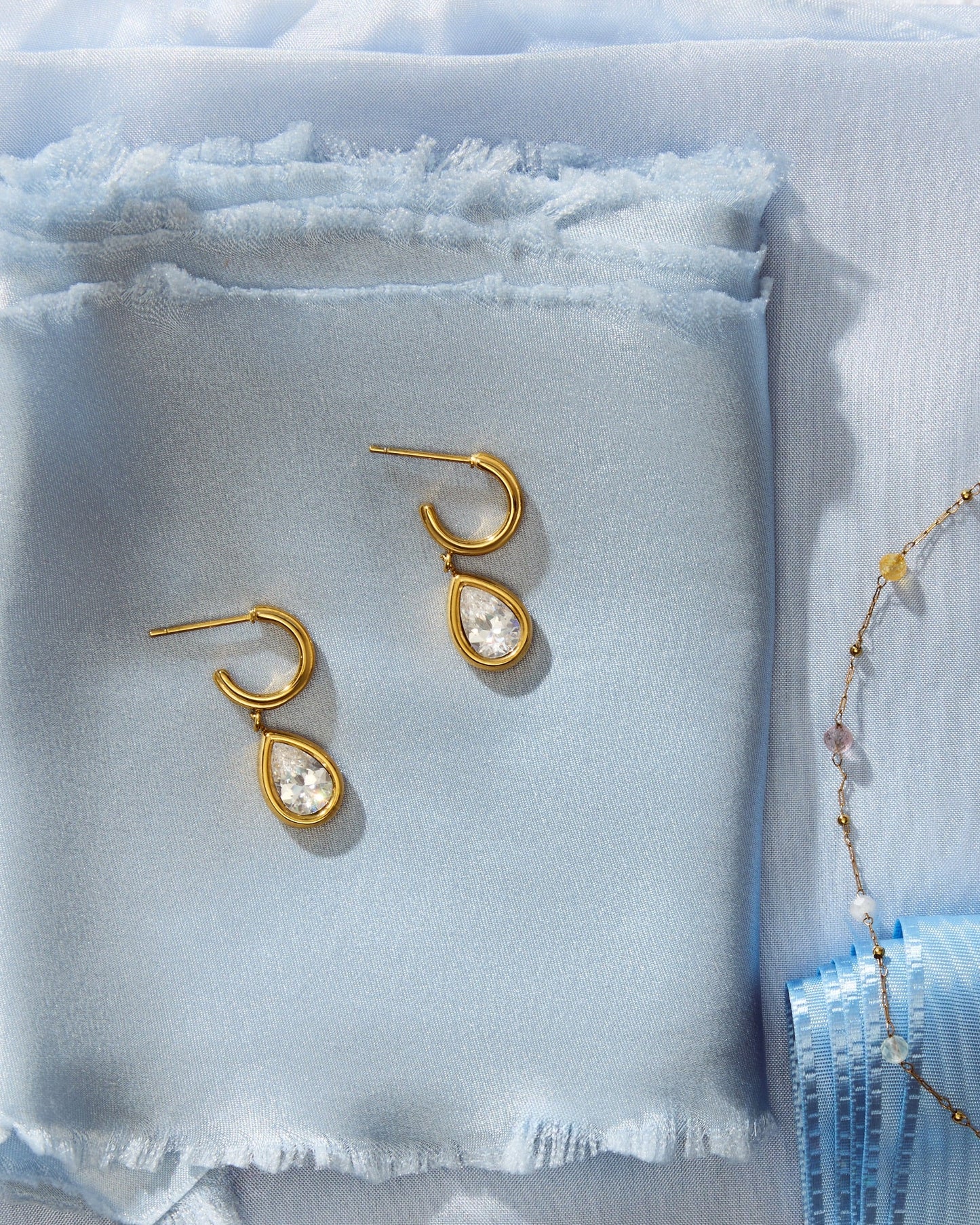 Julie Earrings on light blue fabric