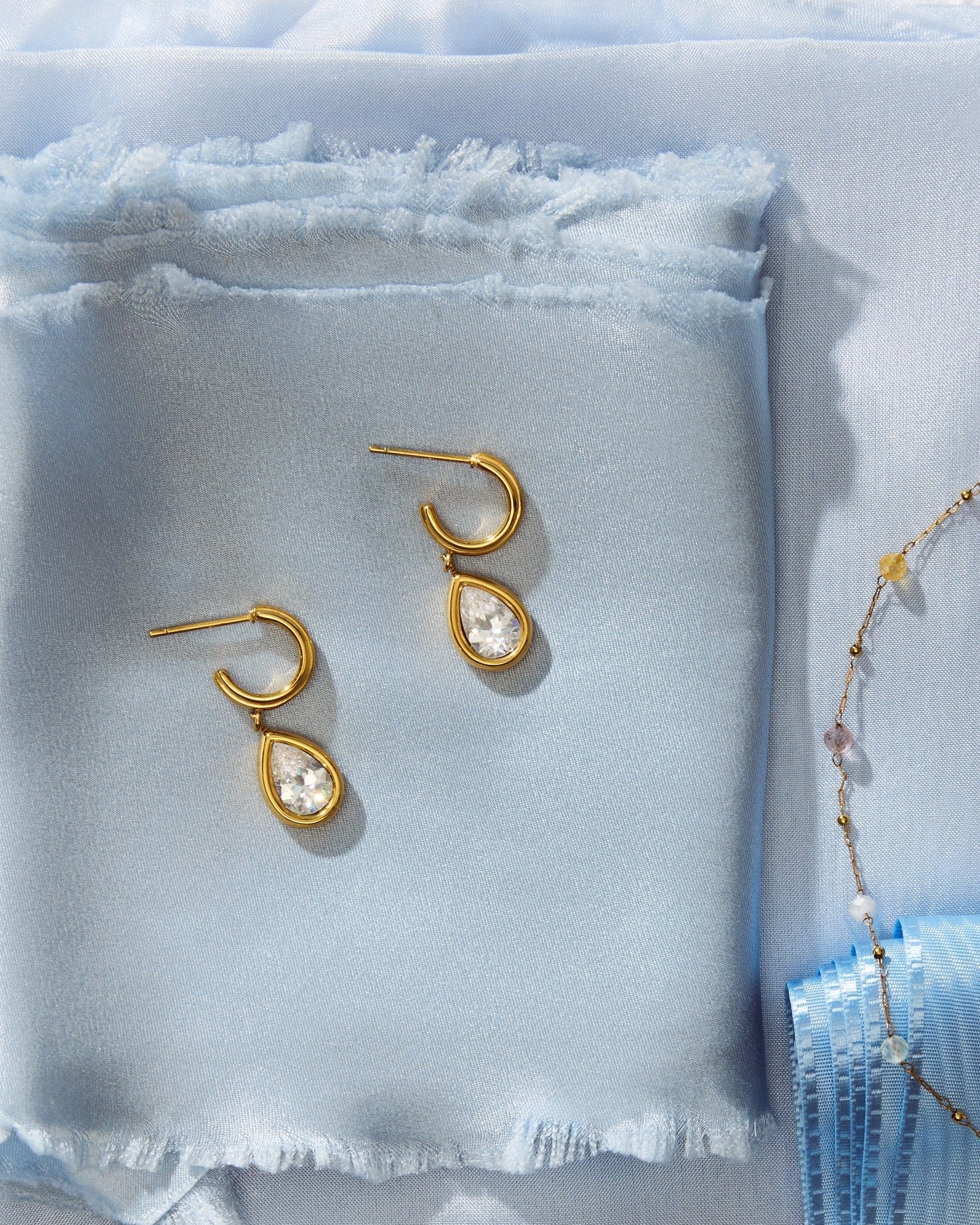 Julie Earrings on light blue fabric