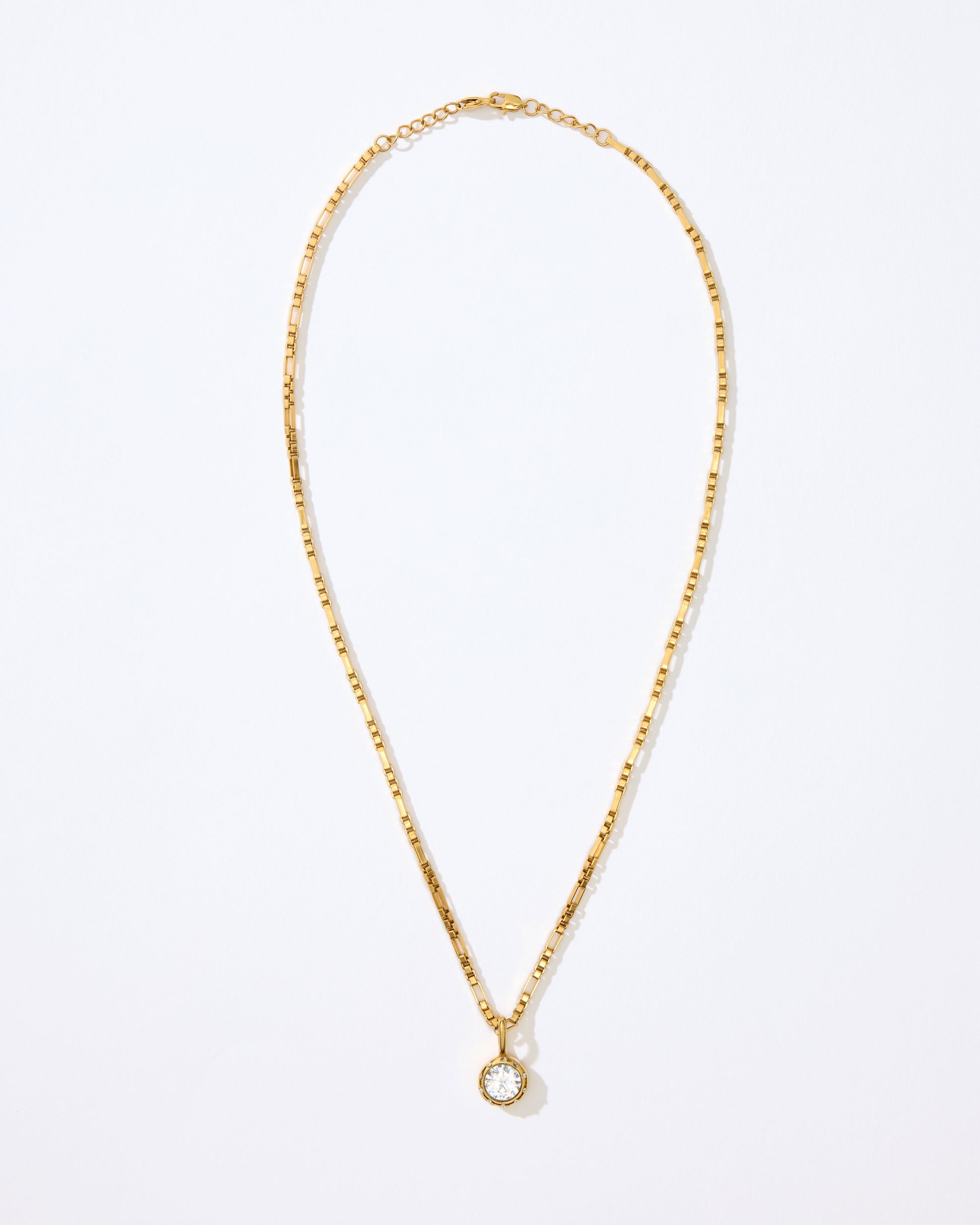 Gold necklace with the Louise pendant on a white background.