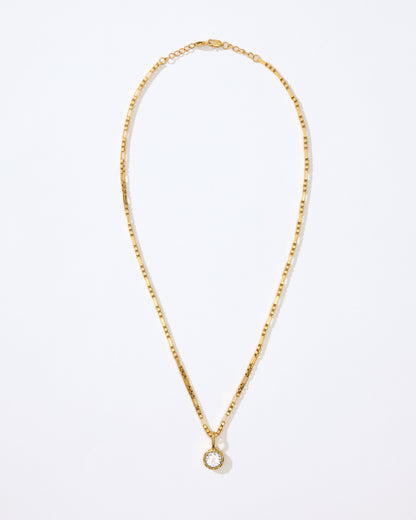 Gold necklace with the Louise pendant on a white background.