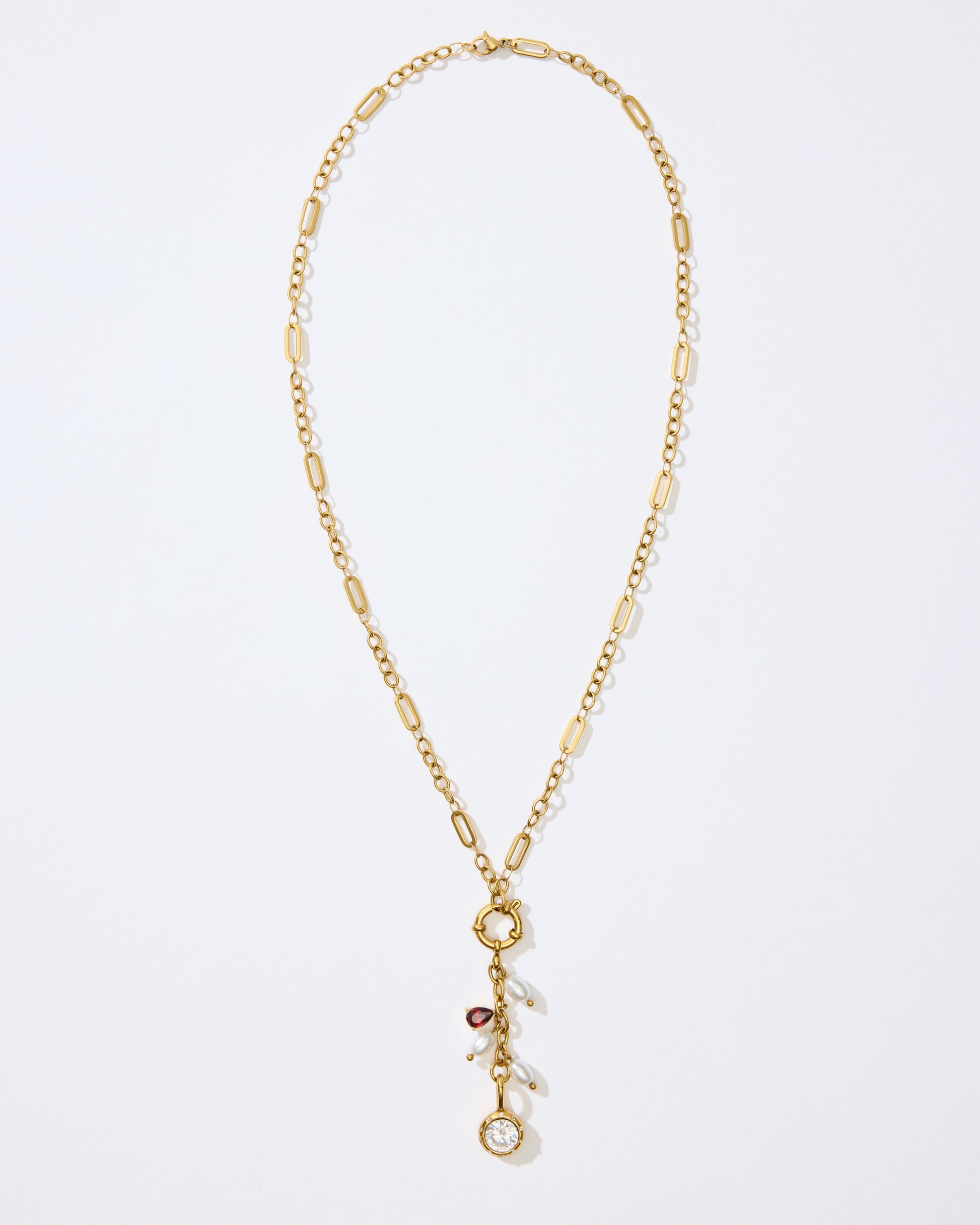 Gold Necklace with charms and pendants on a white background. 