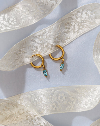 Vivi Earrings looped through a piece of lace ribbon